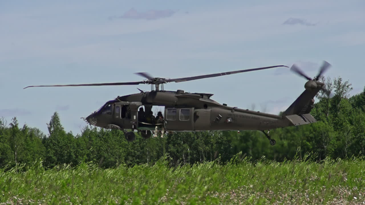 슬로모션으로 숲에 착륙하는 블랙호크 군용 헬리콥터