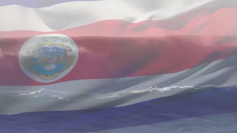 digital composition of waving costa rica flag against waves in the sea