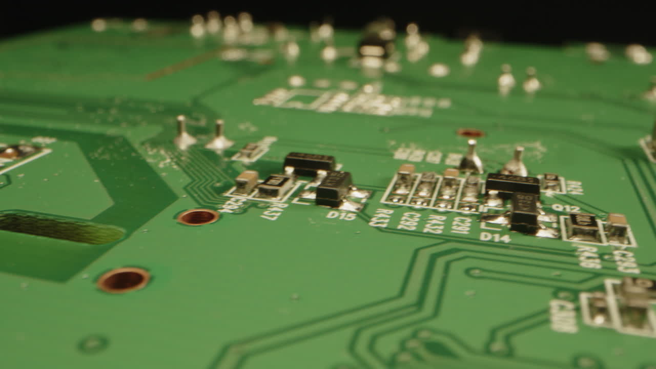 Beautiful macro dolly from the microchip on a printed circuit board over the full green plate