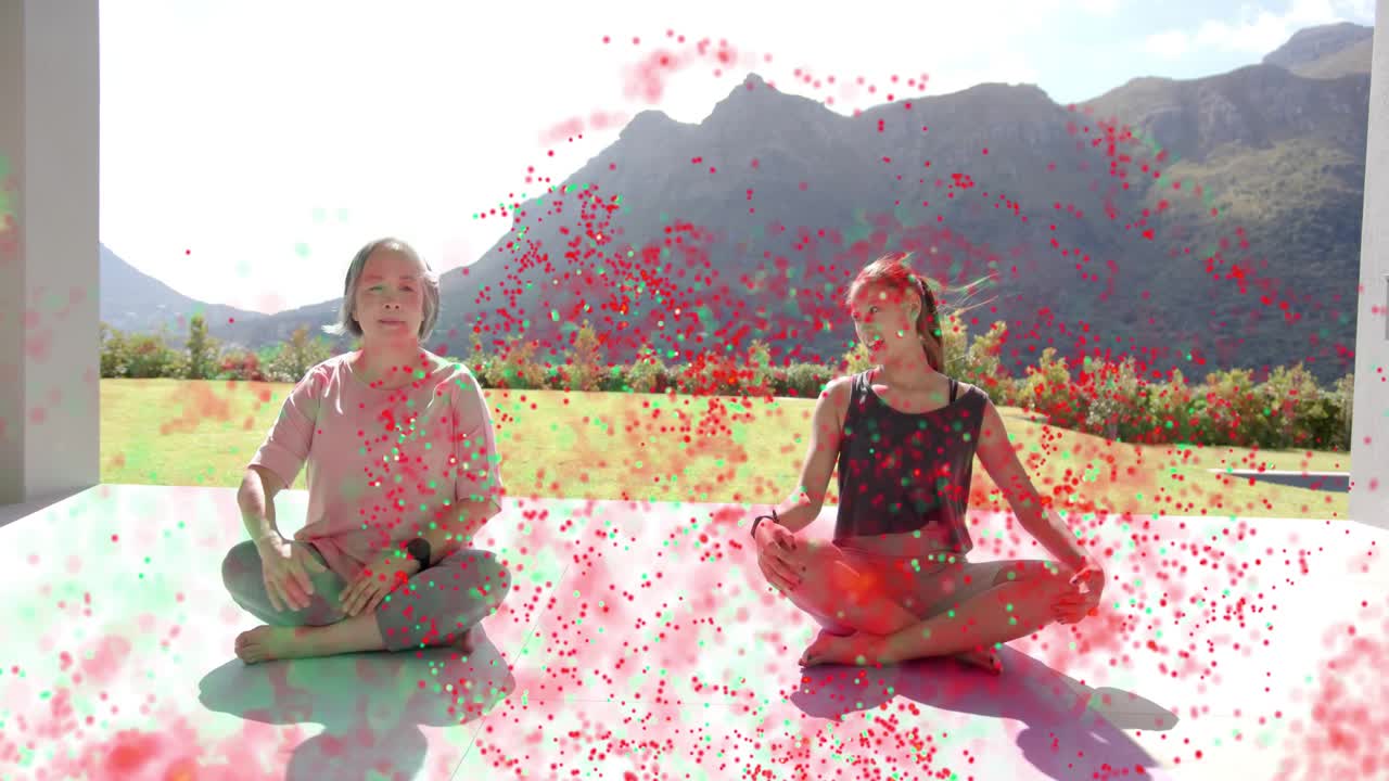 Instructor cue guiding two women stretching on mat on patio for fitness, particles overlaying frame