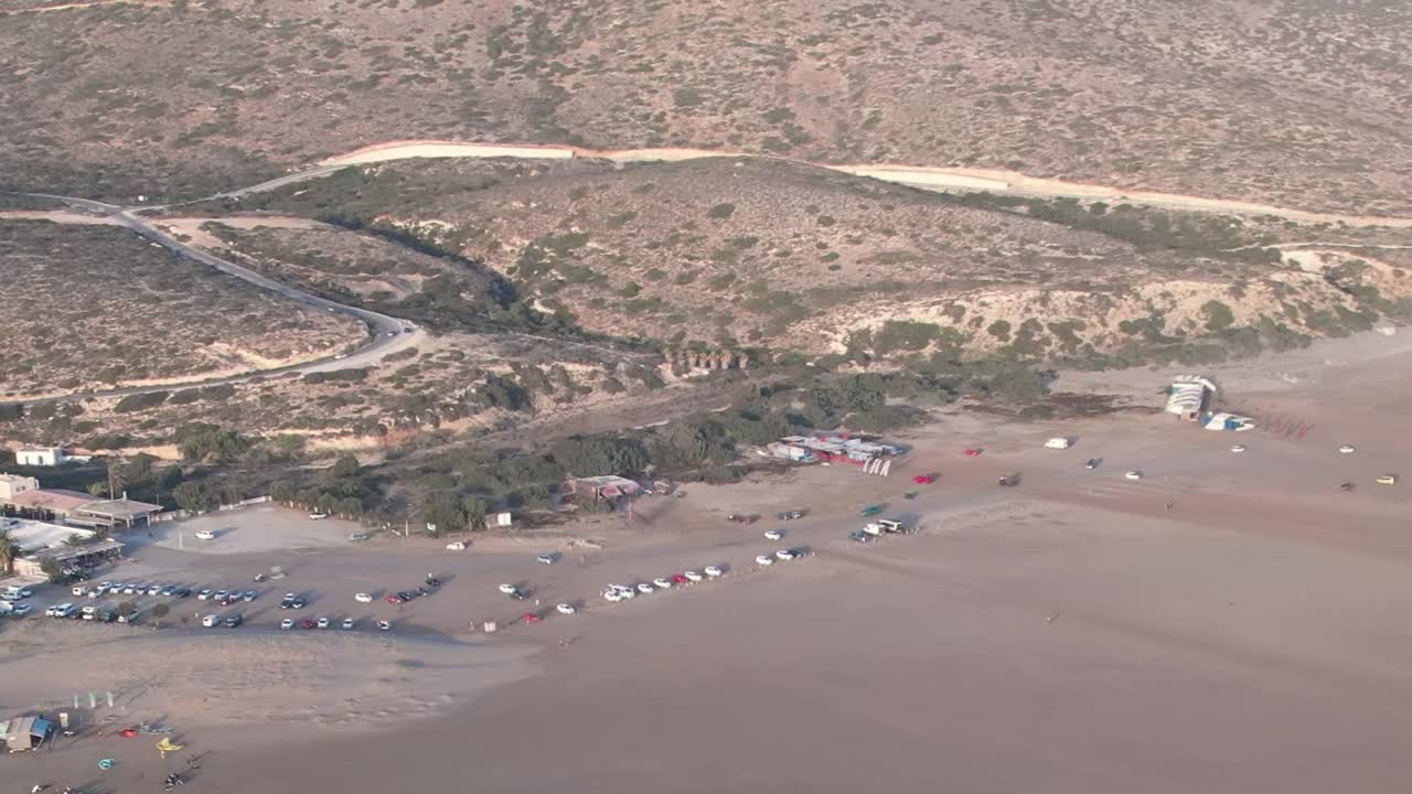 Scenic aerial view of a beach in Greece with boats and visitors
