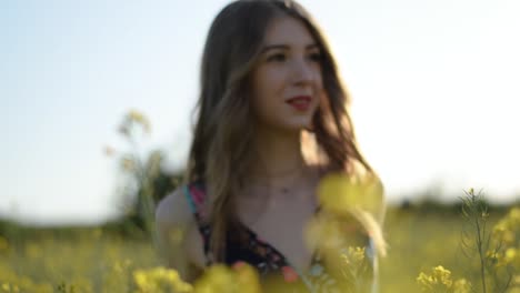 Woman-gazing-around-a-meadow-of-yellow-plants