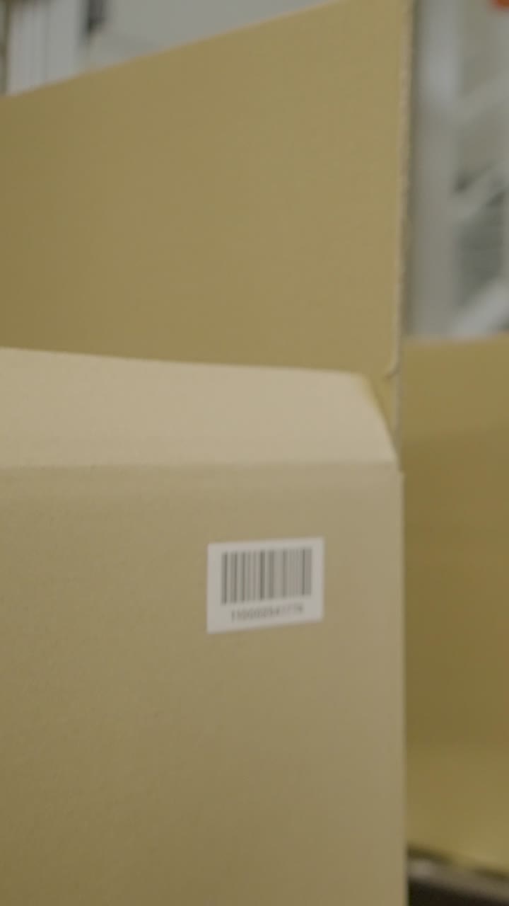 Cardboard box with barcode in a warehouse, concept of logistics industry