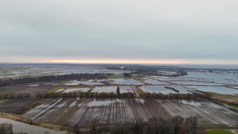 aerial establishing shot of flooded fields during autumn rain season