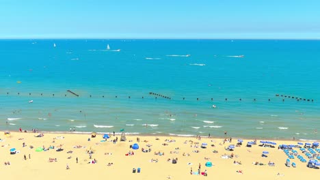 descending aerial shot of north avenue beach in chicago illinois | noon time lighting