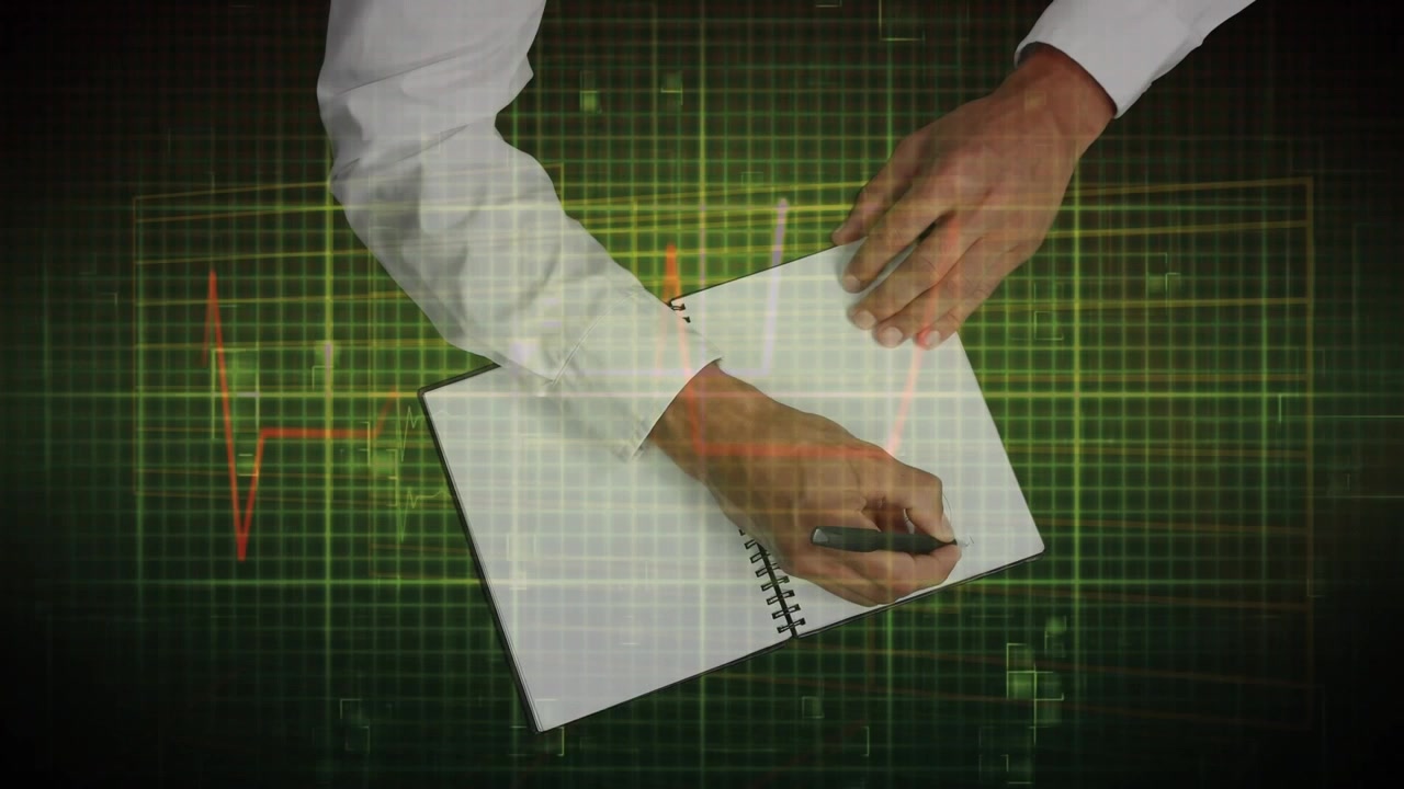 Animation of heart rate over hands of cauasian man writing on green background