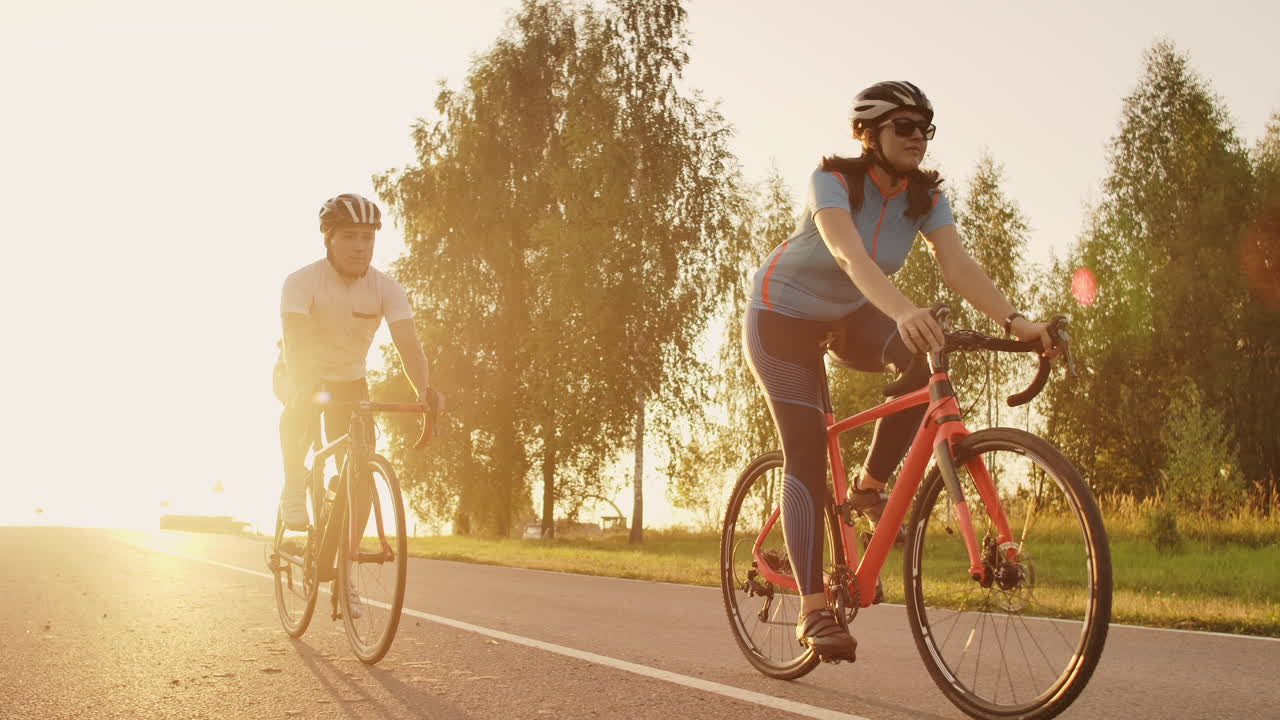 Tracking shot of a group of cyclists on country road. Fully released for commercial use.