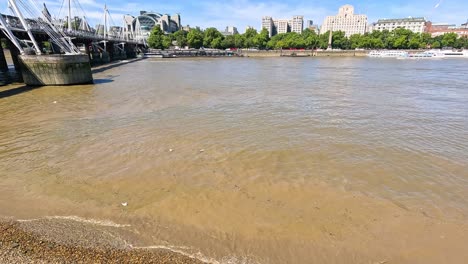 waves gently lap against the thames shoreline