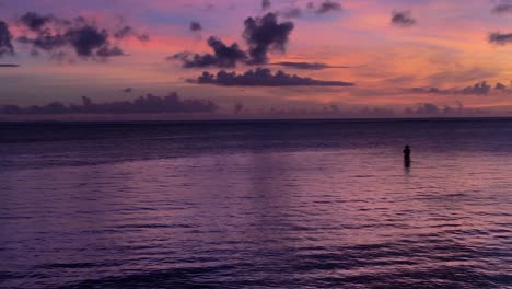 graphic purple sunset with silhouette of lonely fisherman in riviera