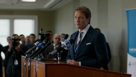 man speaking at a press conference