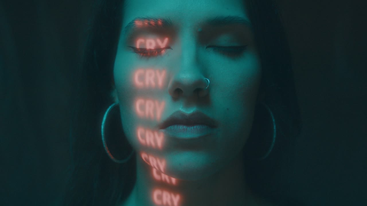 Woman with Neon Cry Words on Face