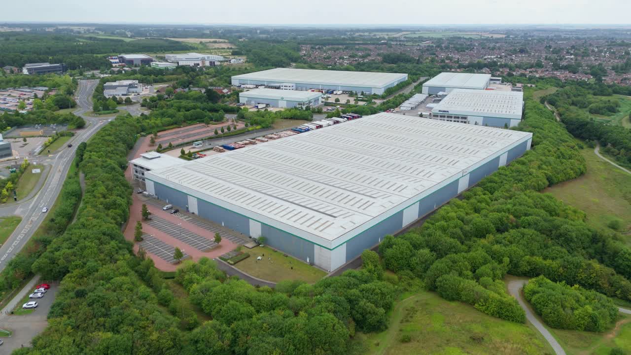 High up aerial drone shot of modern warehouse and logistics distribution centre with bays Kettering England UK