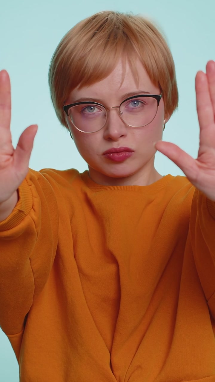Woman say no hold palm folded crossed hands in stop gesture warning of finish prohibited access