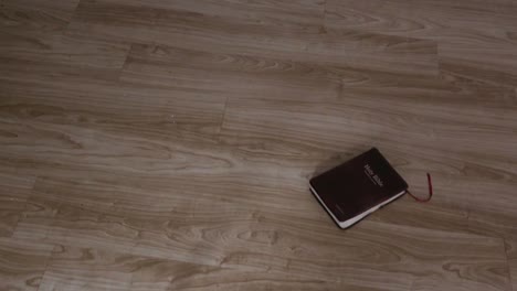 Slow-Zoom-in-of-KJV-Bible-on-hardwood-floor-Background