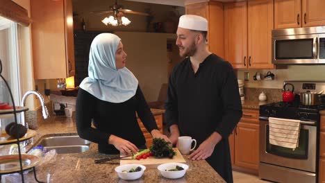 middle eastern young couple make salad she chops track left