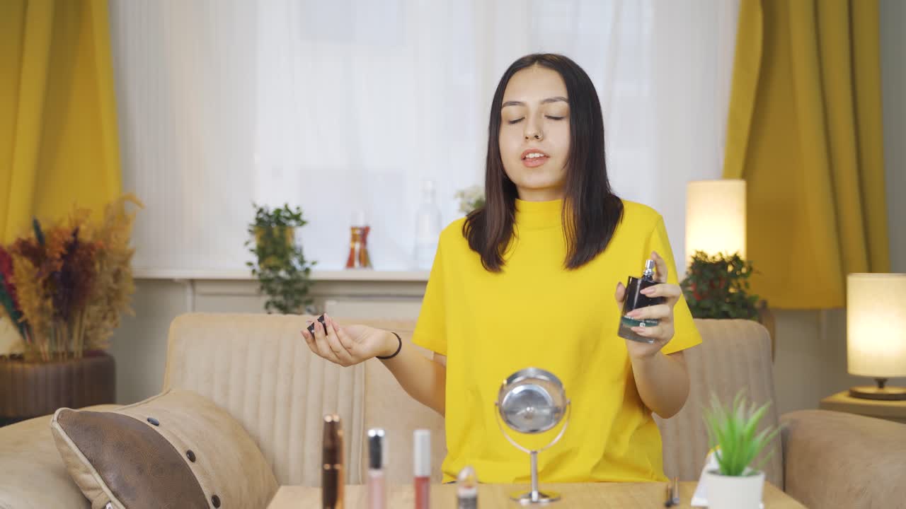Young woman spraying perfume, good smell.