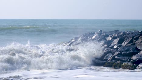 slow motion big frothy whitewash waves crashing over rocky seawall in southern sri lanka