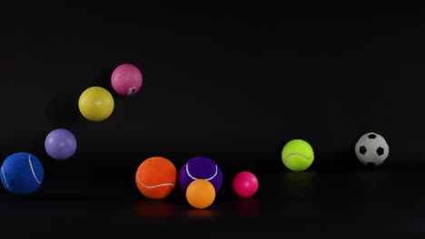 various balls bouncing on a dark surface