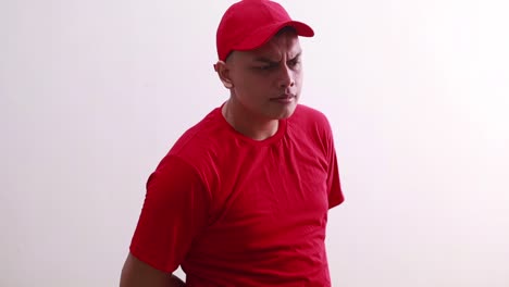 young asian man in red standing with courious face expression