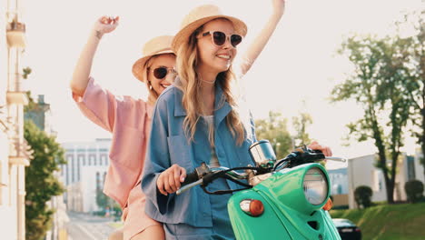 two friends enjoying a scooter ride