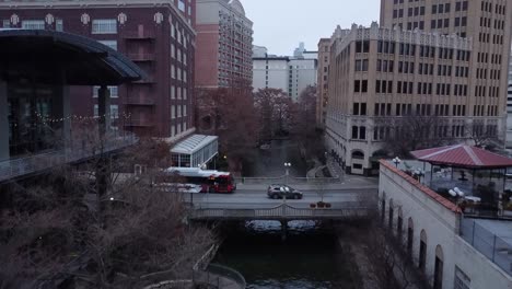 a drone glides in slow motion over a city river, capturing rippling water, glowing lights, and bridges in detail.