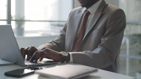 african american businessman working on laptop at office desk