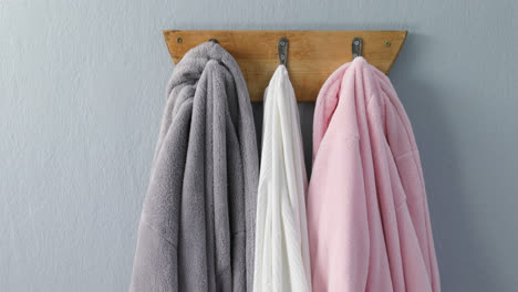 Various-bathrobes-hanging-on-hook-4k