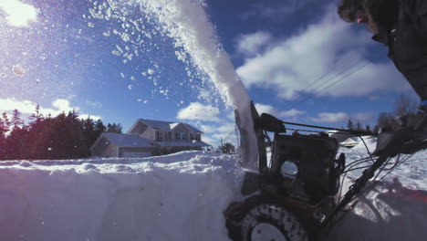 super slow motion snow flying out of a snowblower on a frigid winter day