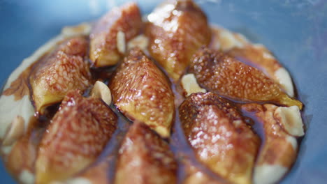 figs hummus bowl closeup. traditional mediterranean cuisine seasoned appetizer