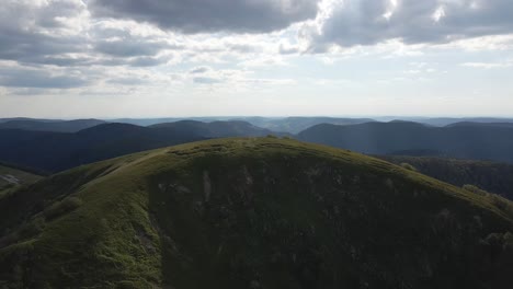 aerial shot over mountains. cloudy shot with mountains in the background. les vosges, france, summit of the kastelberg