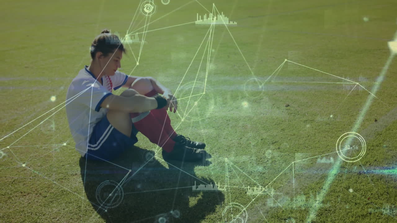 Soccer player sitting on field with digital data processing animation overlay