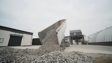 a truck dumps rubble onto a construction site. clearing site