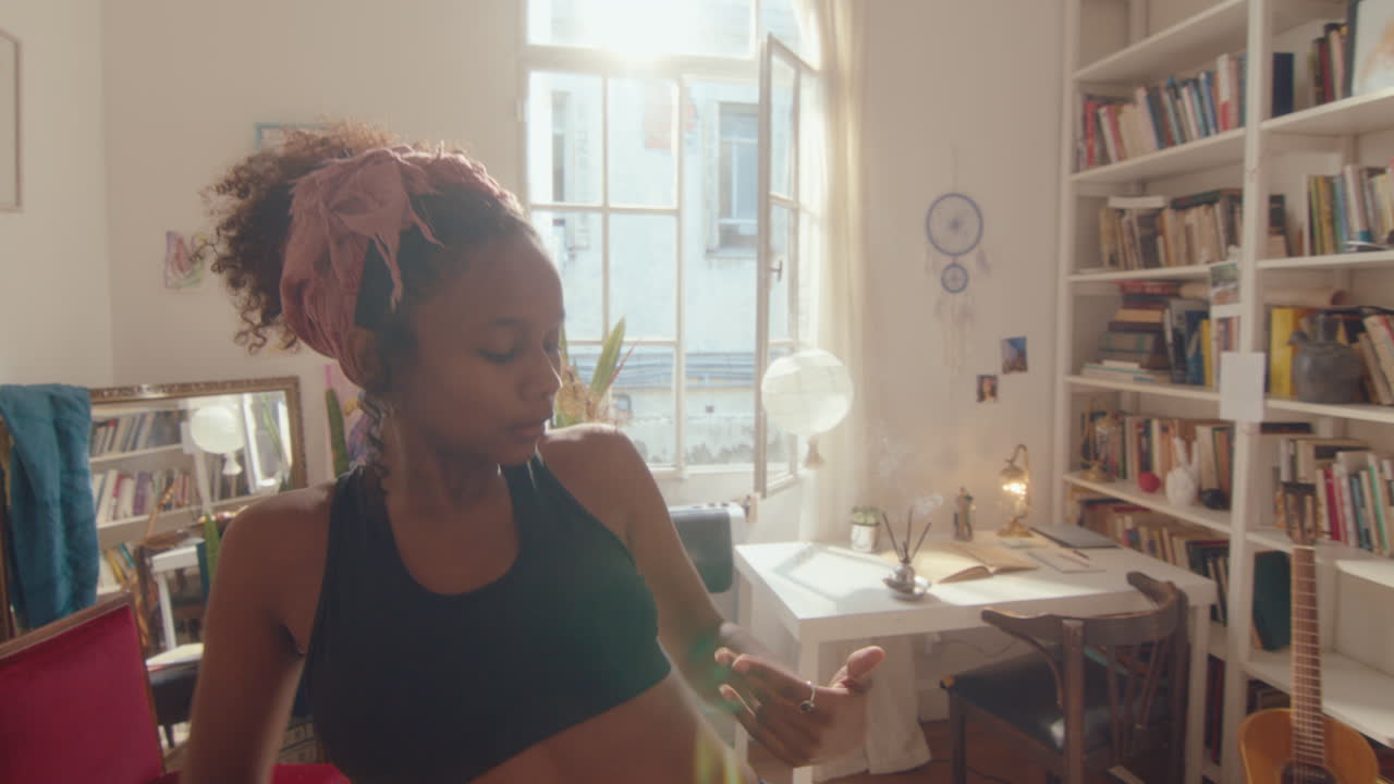 Young Attractive Black Girl Dancing Sensually in Sunlit Room