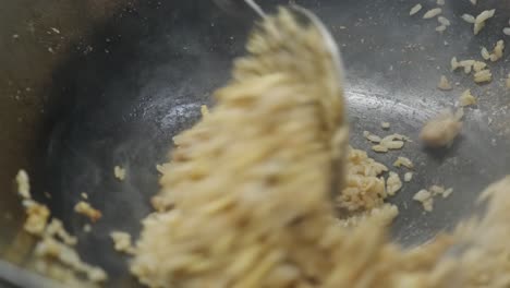 a dish of rice and meat is cooked in a pan