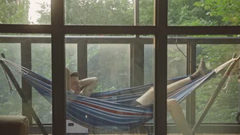 young man lying in a hammock - wide shot