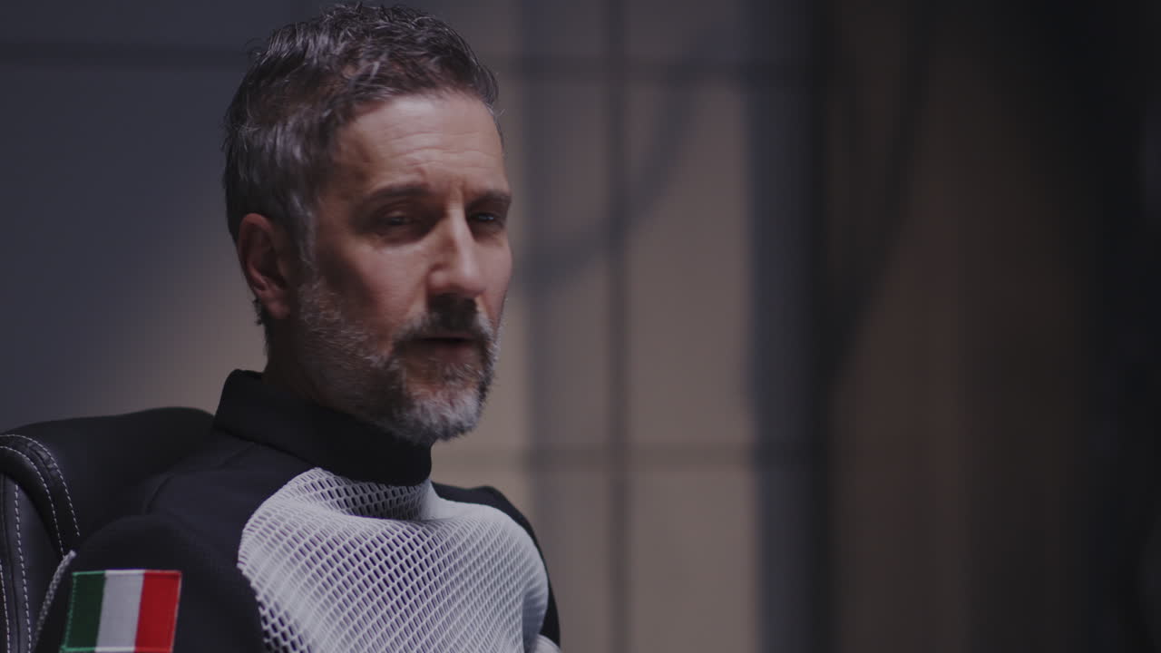 Man in Space Suit Discusses Research