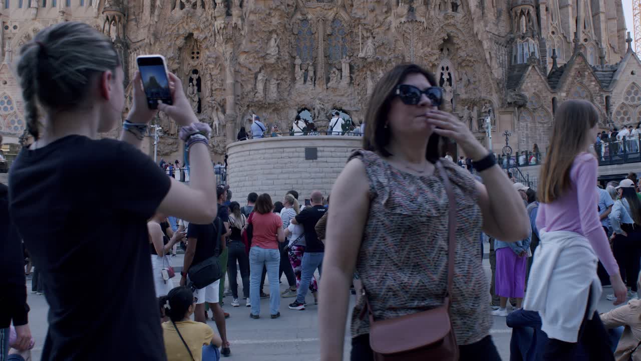 Crowd of tourists enjoying Sagrada Familia in Barcelona, sunny day