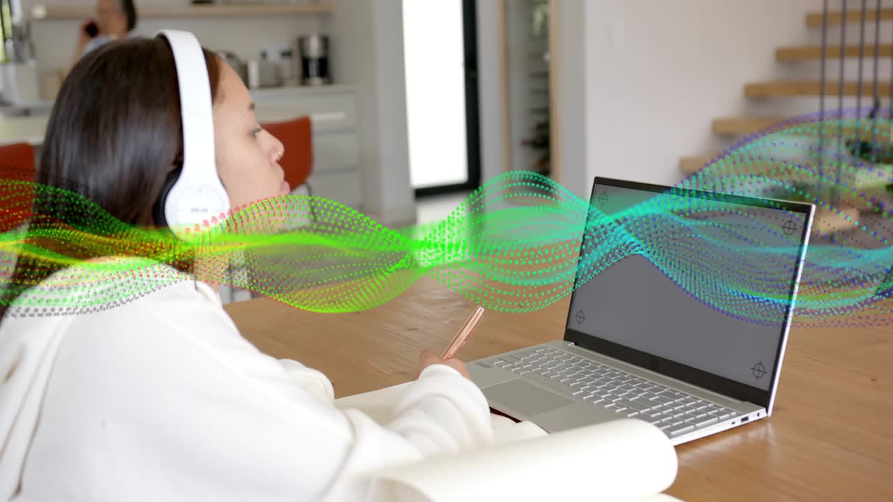 Laptop starting audio, teen wearing headset holding phone, waveform sweeping, tracking for music