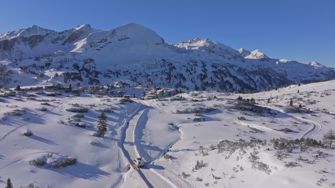 Aerial view of camper van on a fresh-snow road in Obertauern, Austria