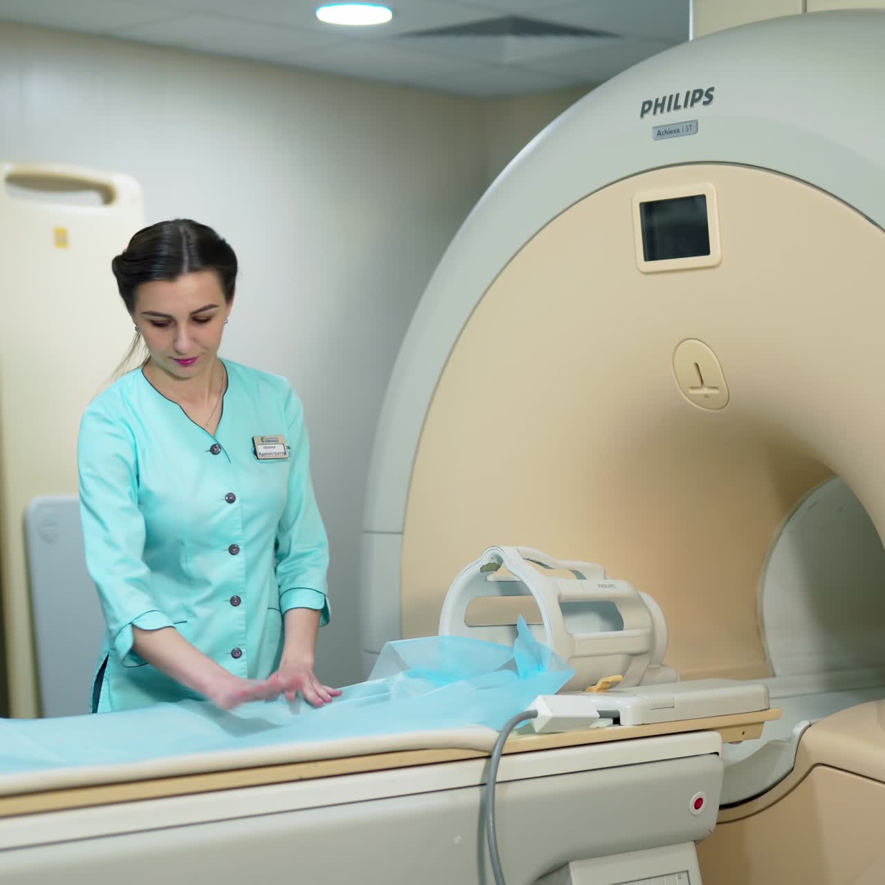 Modern magnetic resonance device in clinic. Laboratory worker prepares the MRI machine before the scan procedure.
