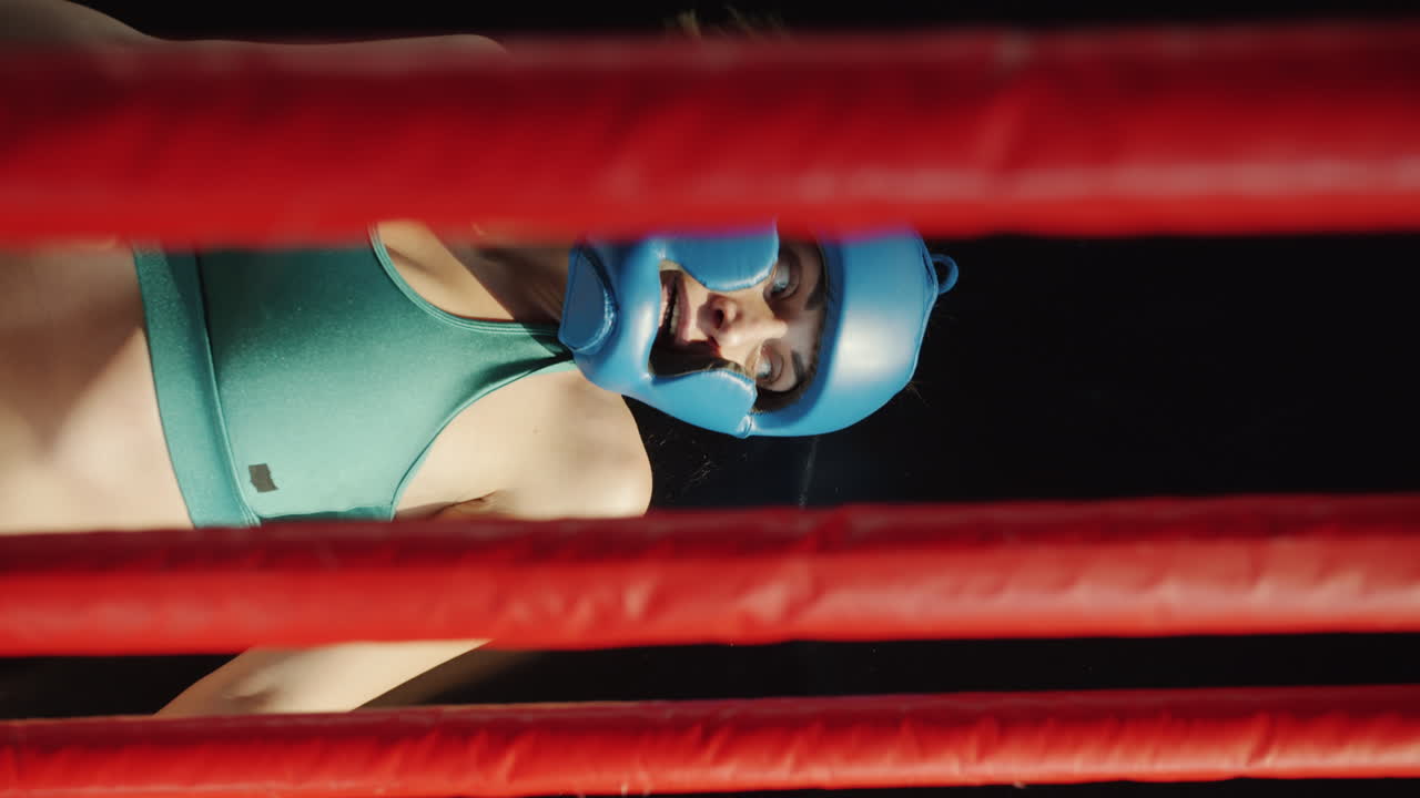 Female Boxer Lying in Boxing Ring