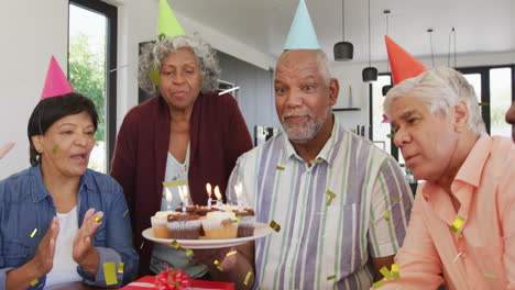 birthday celebration with confetti animation over diverse group of people with cake