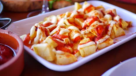 un delicioso plato de patatas, servido con una salsa deliciosa rociada en la parte superior