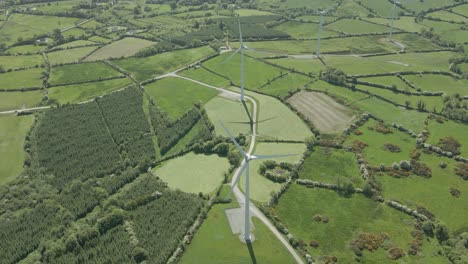 countryside fields with wind turbines - eco-friendly source of electricity