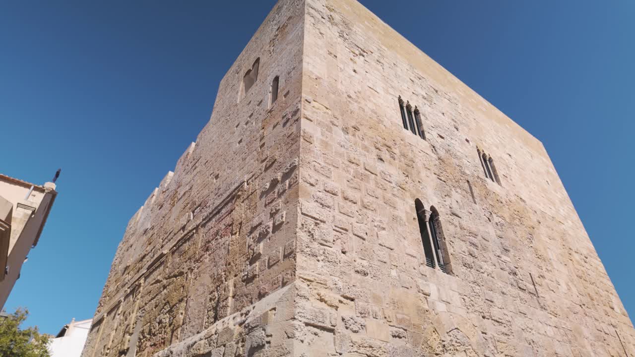Establishing Torre del Pretori in Tarragona, historic Roman structure by the Mediterranean, exterior weathered sun worn walls