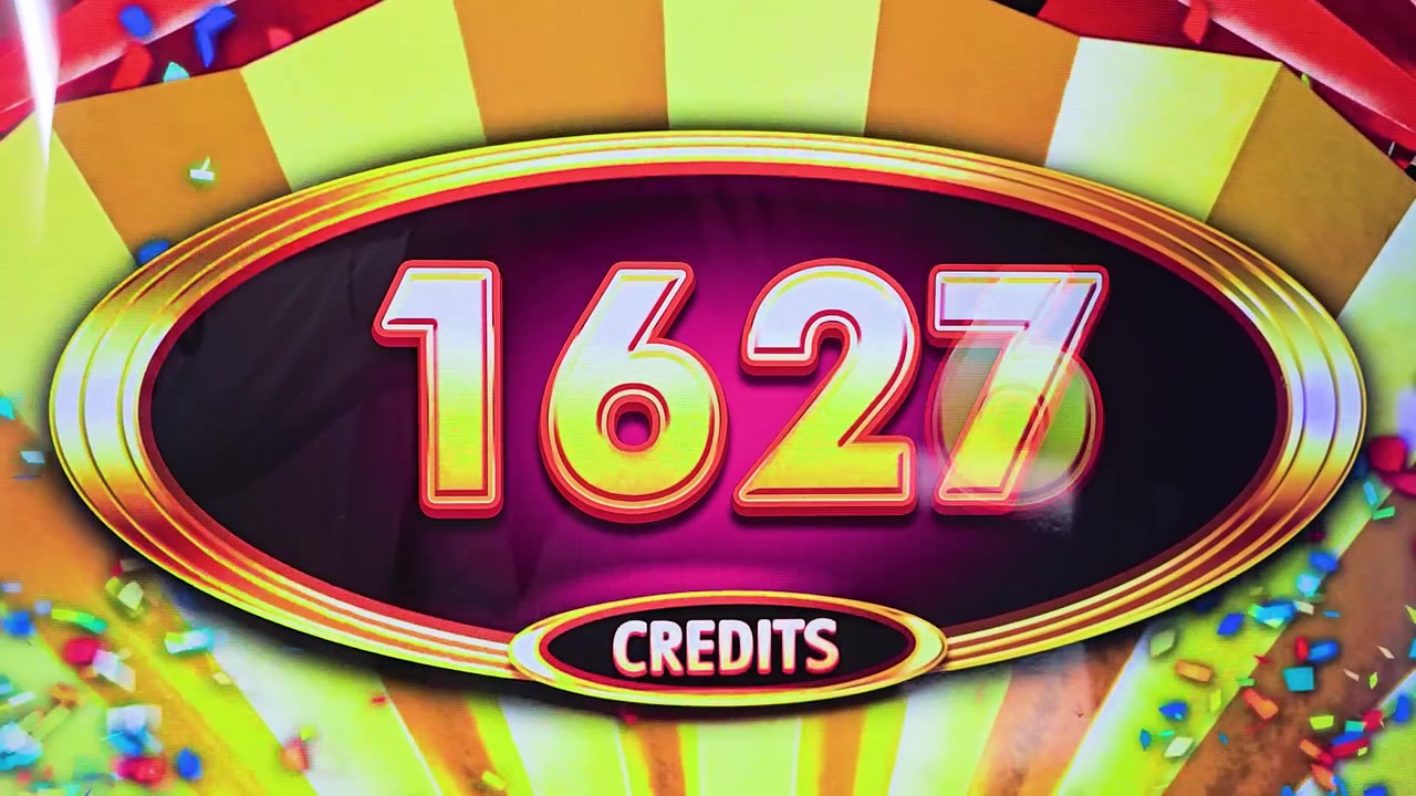 Colorful casino slot game payout screen with bright credits, gold coin imagery, glossy display reflections, and vivid arcade lighting for jackpot and entertainment videos.