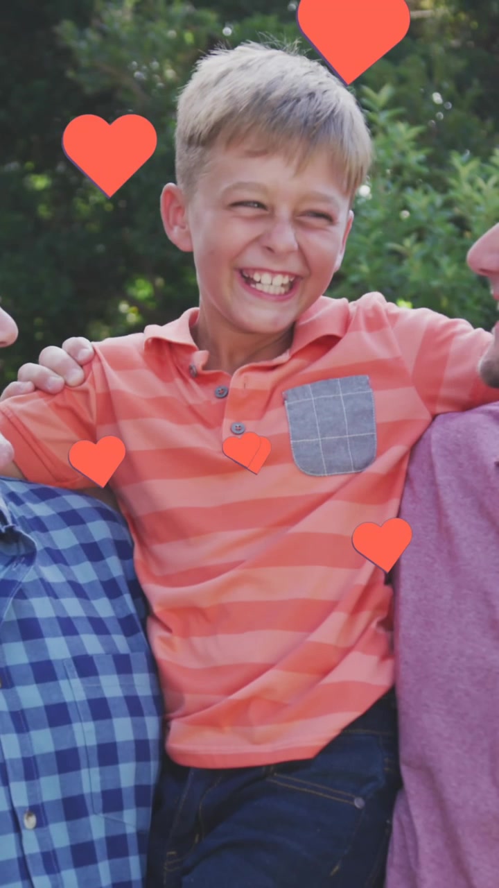 Animation of hearts over happy caucasian three generation men hugging in garden