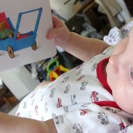 baby playing with story book