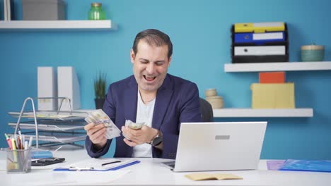 Businessman-counting-money-looking-at-camera.