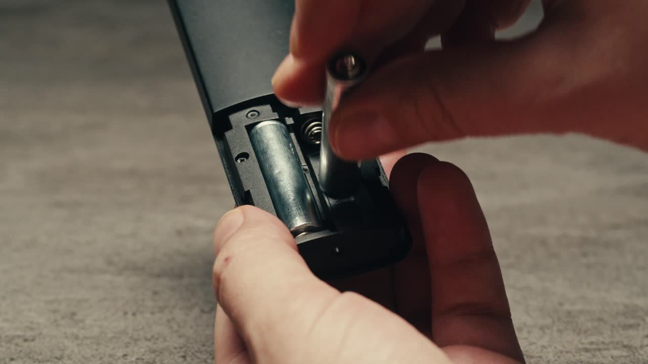 Adding silver batteries AA and AAA in remote controller TV close-up. Batteries are common in portable electronic devices. An AA battery is composed of a single electrochemical cell that may be either a primary battery or a rechargeable battery. Several different chemistries are used in their constru